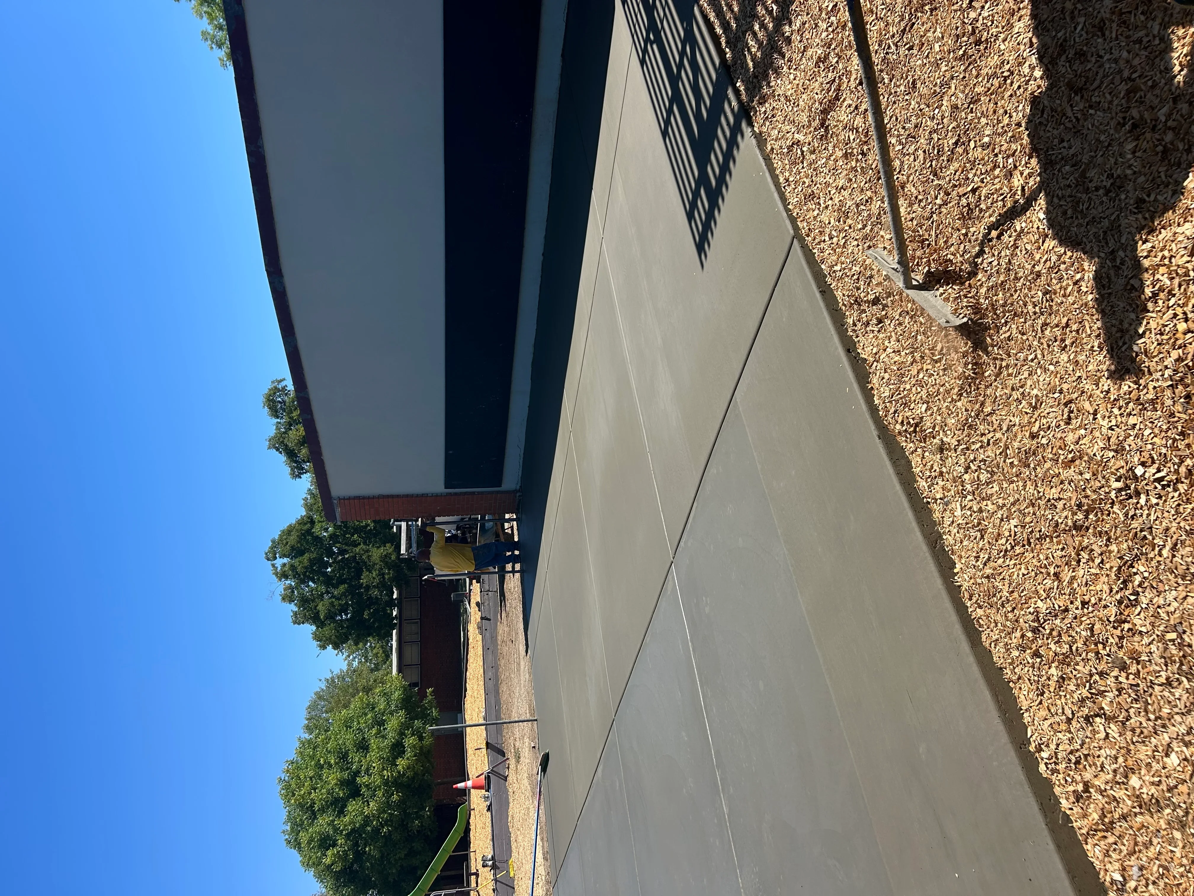 Newly installed concrete driveway with control joints and finished surface