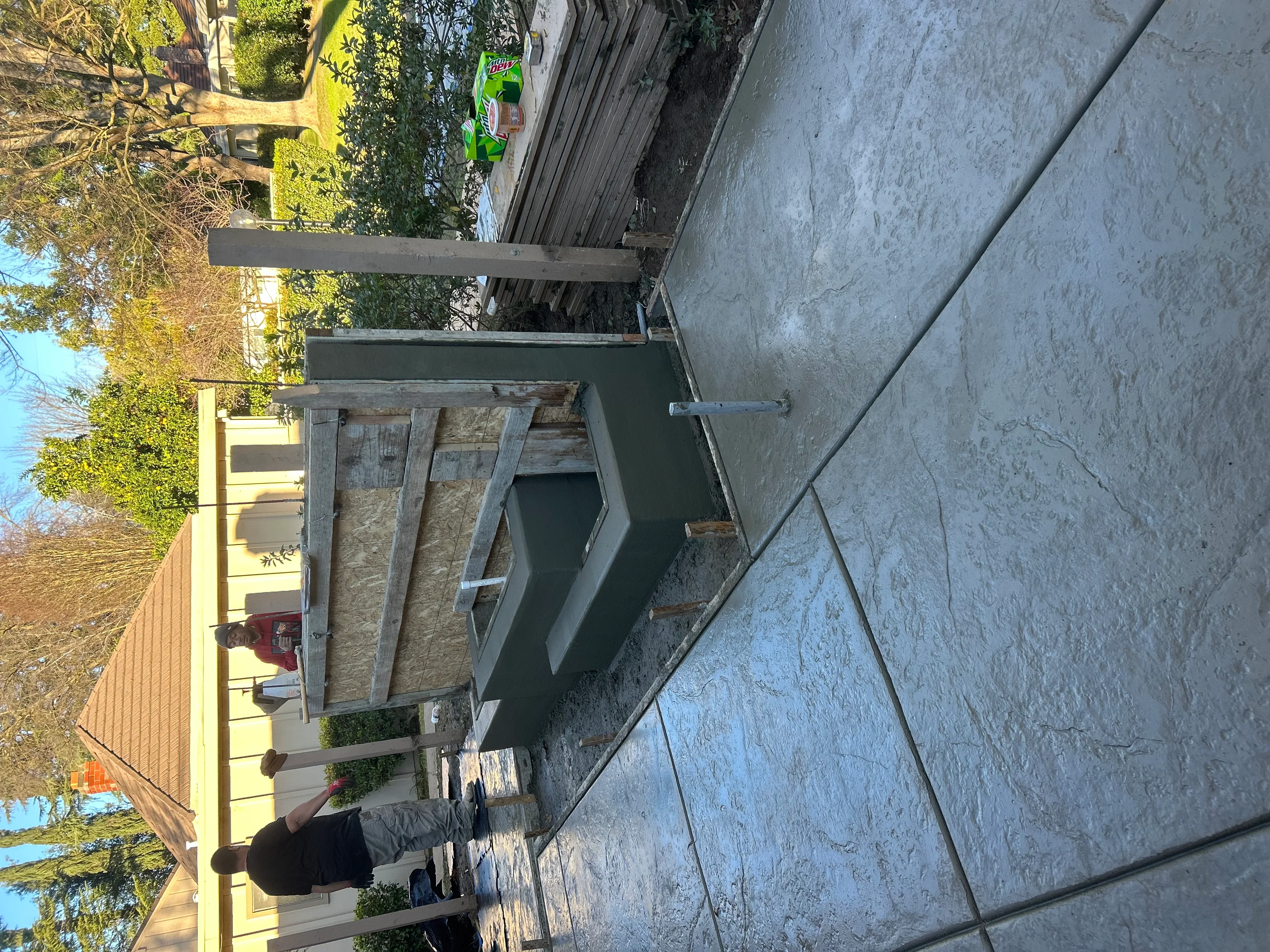 Newly installed concrete driveway and patio with control joints and proper grading