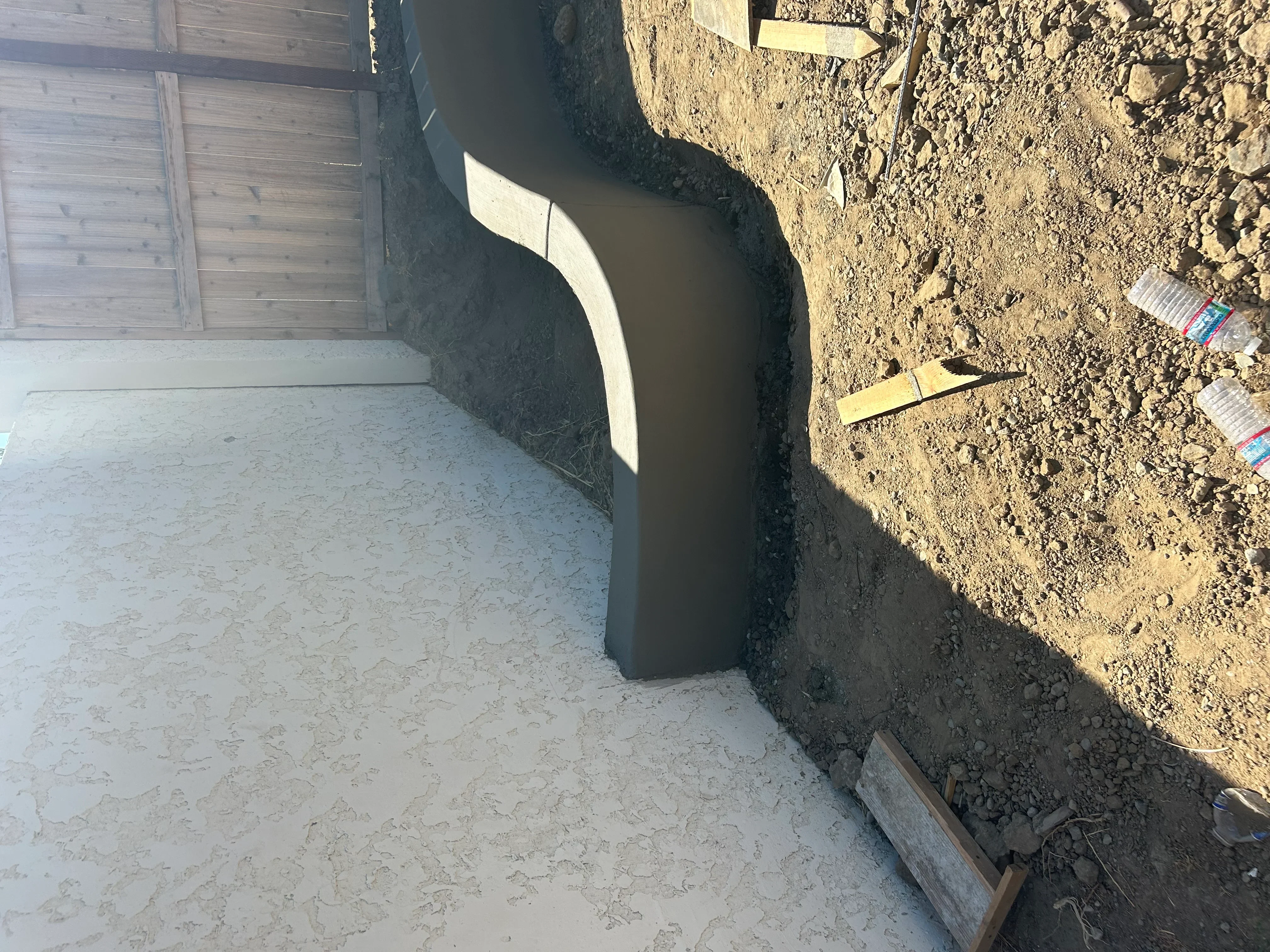 Excavated foundation trench with compacted soil base and wooden forming boards