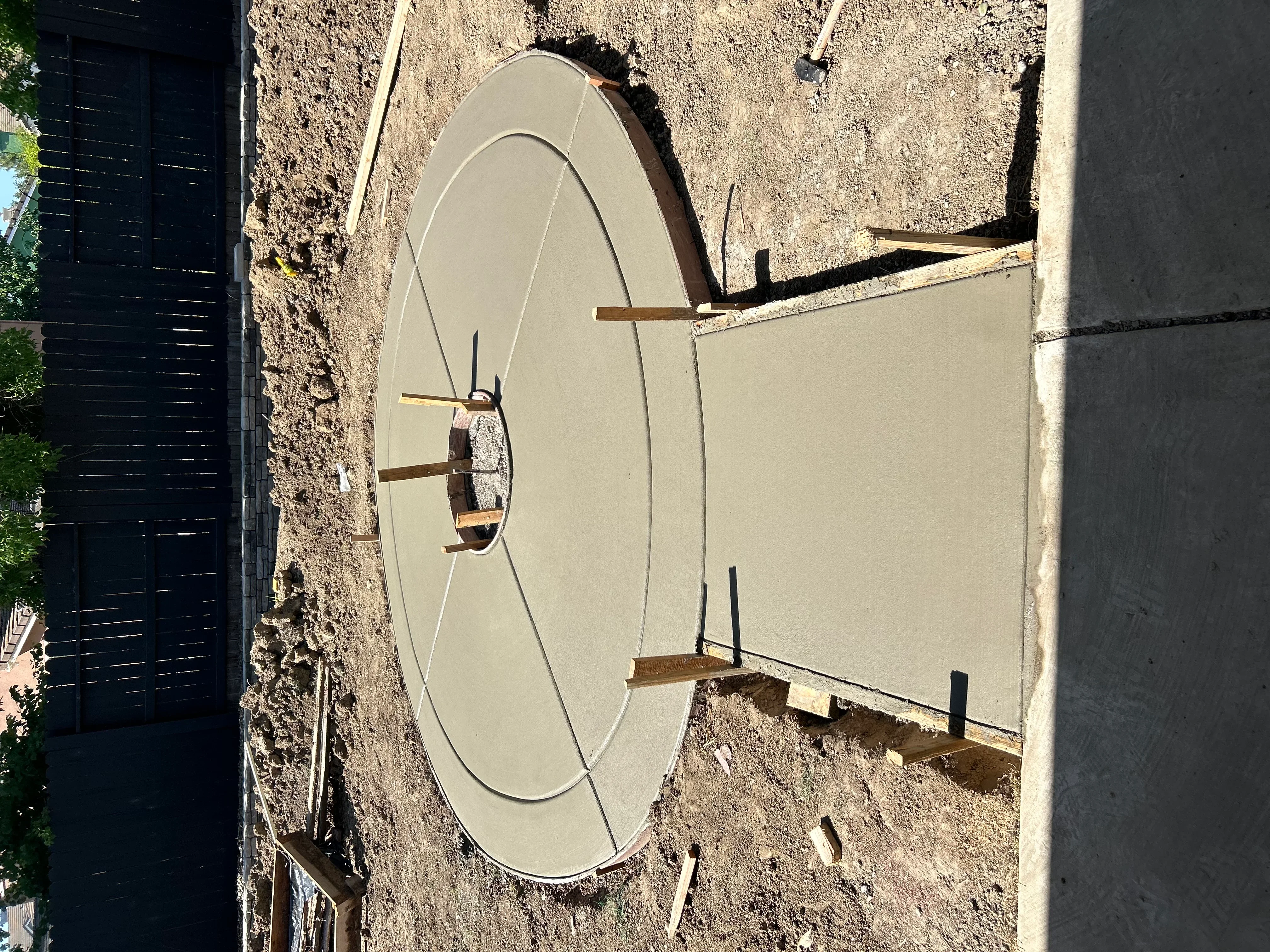 Freshly poured concrete pad with wooden forms and rebar reinforcement