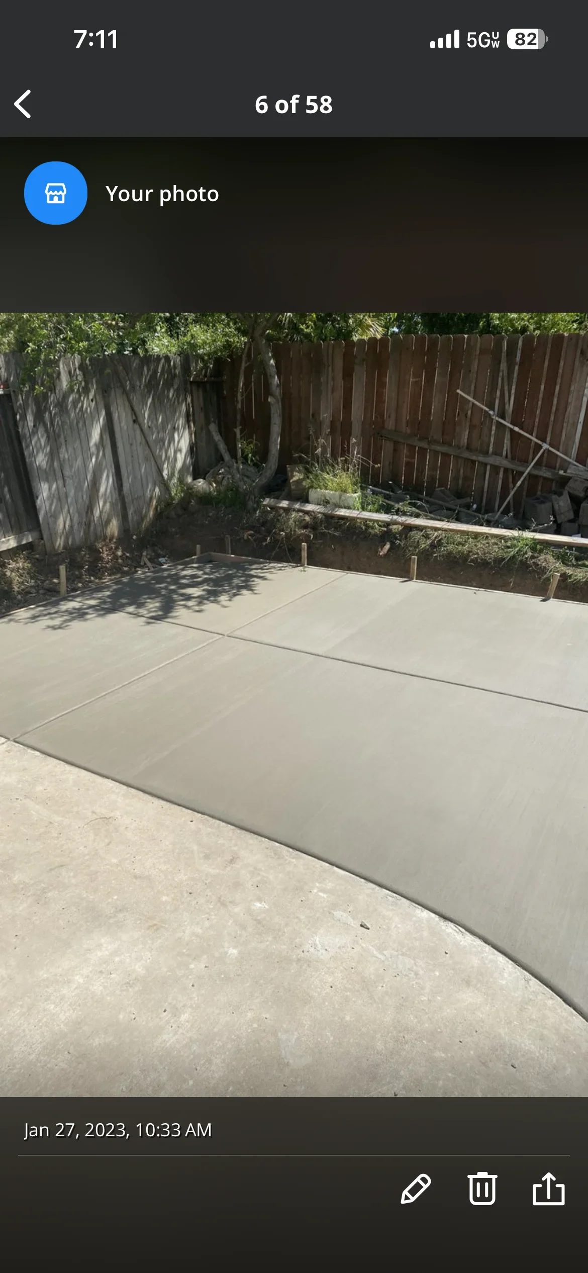 Newly poured concrete patio with control joints in residential backyard