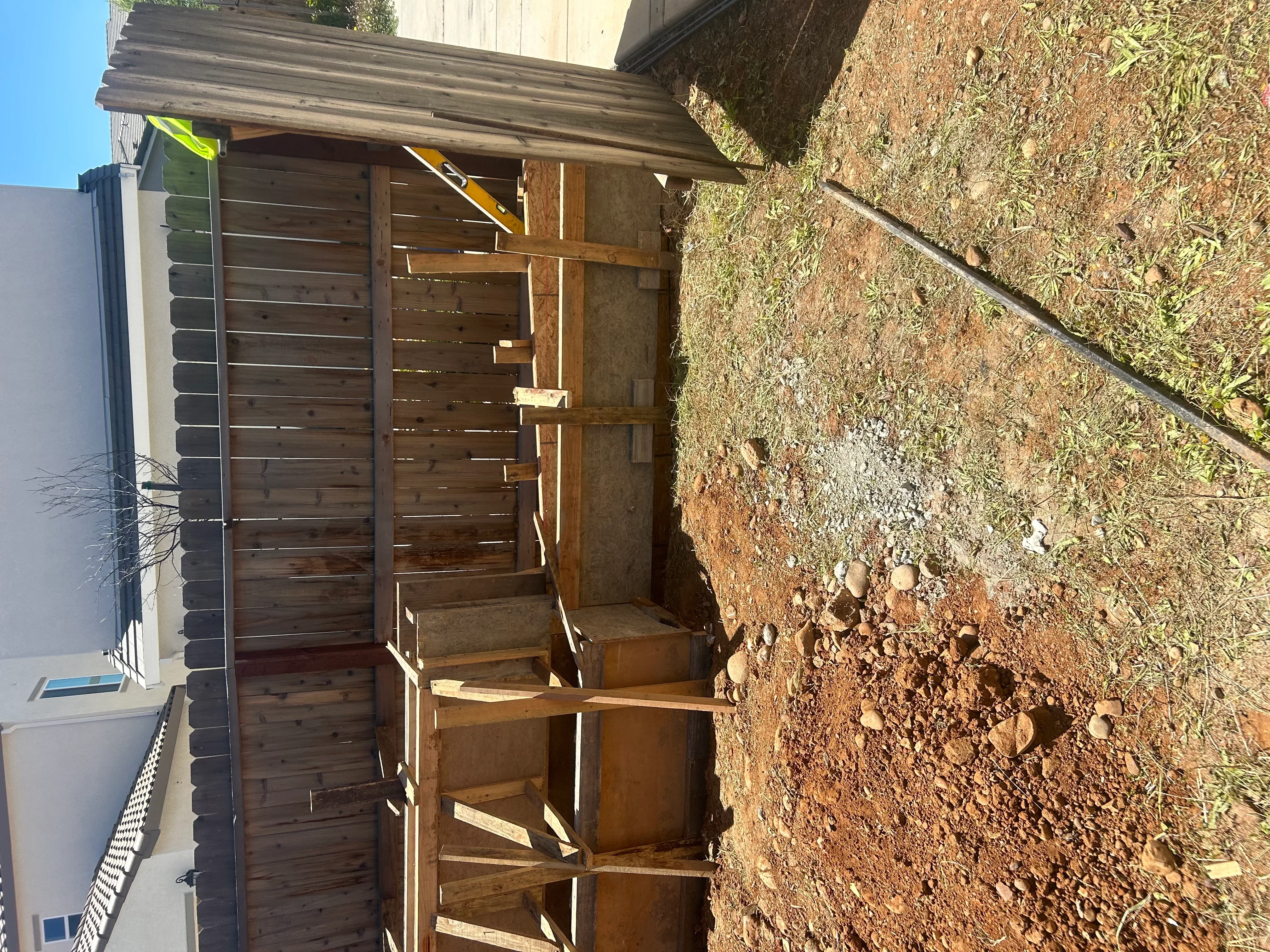 Foundation excavation with wooden forms and bracing on prepared soil site