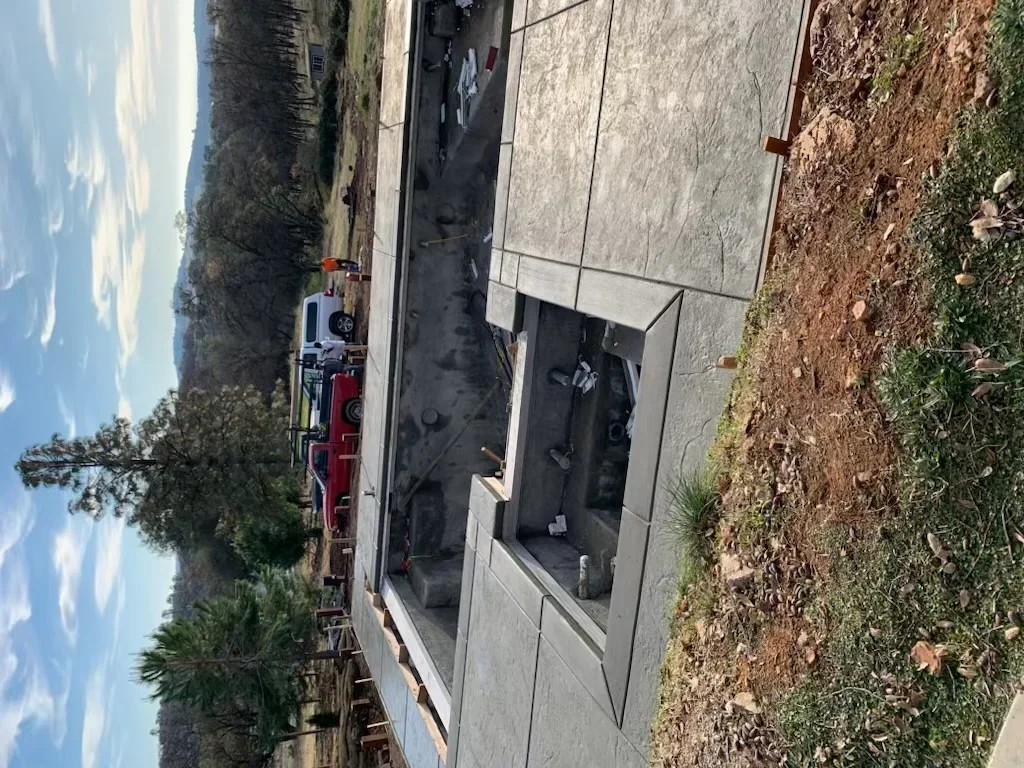 Newly installed residential concrete driveway with finished surface and proper grading