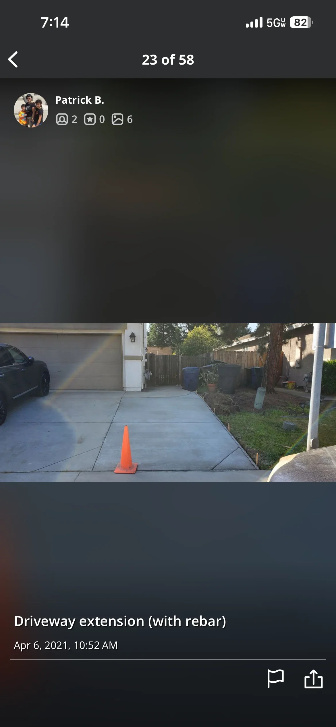 New concrete driveway extension with rebar reinforcement and safety cone