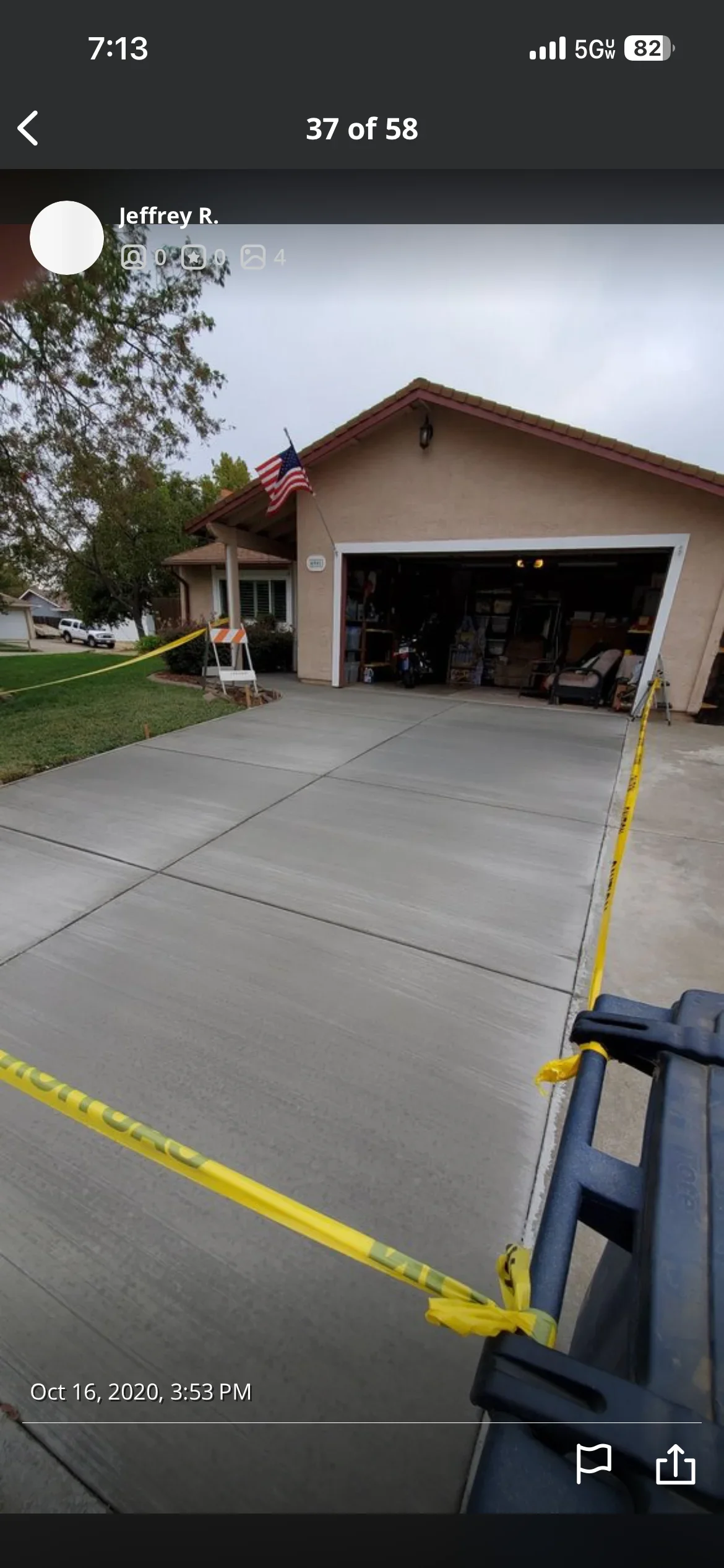 New concrete driveway with control joints in front of residential garage